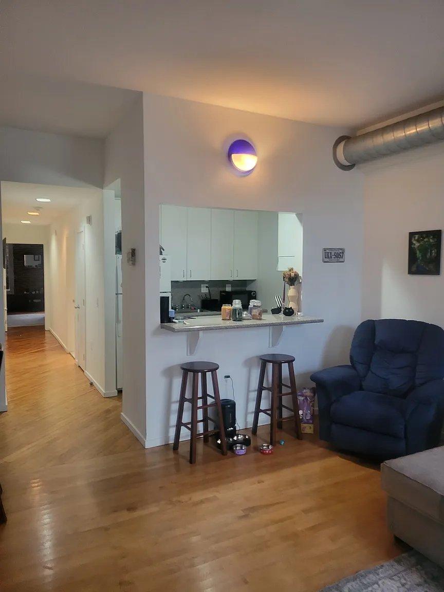 Garden-style 1-bedroom apartment interior at Cotton Hill — hardwood floors, exposed brick, brand new GE stainless appliances